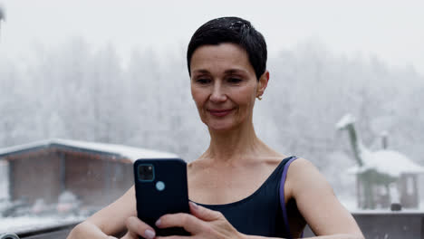 Woman-in-swimwear-with-smartphone