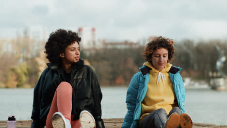 Two-women-talking-and-smiling-outdoors