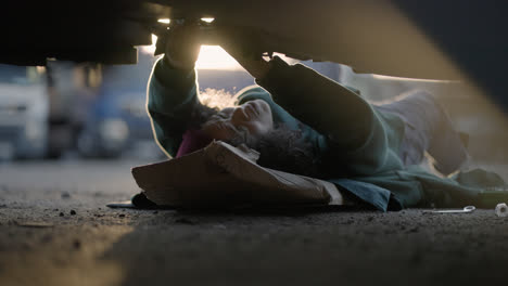 Woman-laying-down-and-working-on-the-road