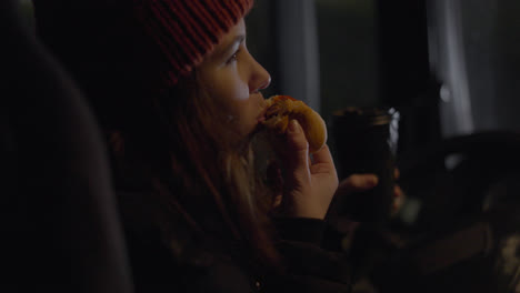 Female-driver-eating-hotdog-and-drinking