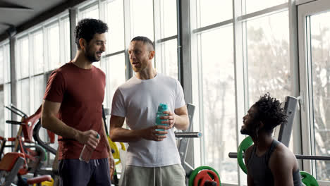 Three-friends-talking-at-the-gym