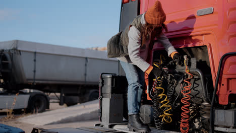 Woman-checking-the-wires-of-the-truck