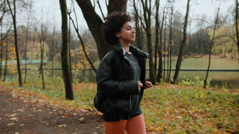 Side-view-of-woman-jogging-outdoors