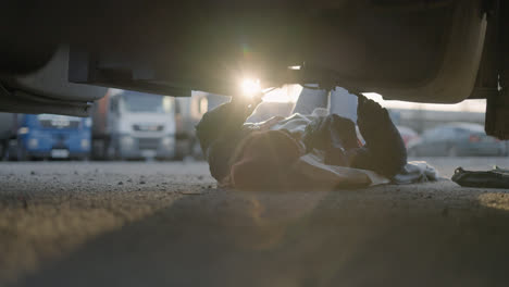 Woman-laying-down-and-working-on-the-road