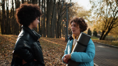 Two-friends-saying-goodbye-outdoors