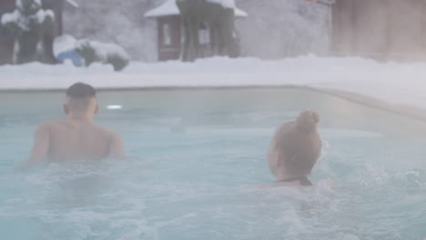 Couple-in-swimwear-going-out-of-the-hot-tub