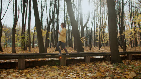 Side-view-of-woman-jogging-outdoors