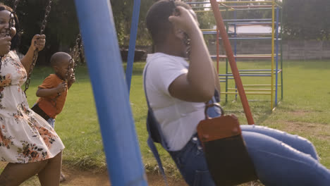 Family-playing-on-the-swings