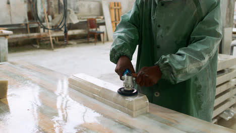 Man-polishing-marble