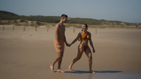 Cute-couple-walking-towards-the-sea