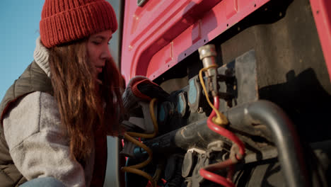 Woman-checking-the-wires-of-the-truck