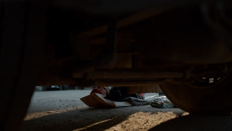 Woman-laying-down-and-working-on-the-road