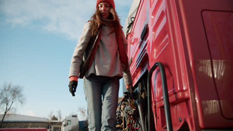 Woman-checking-the-wires-of-the-truck