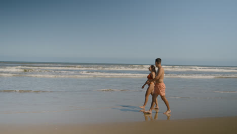 Cute-couple-walking-on-the-beach
