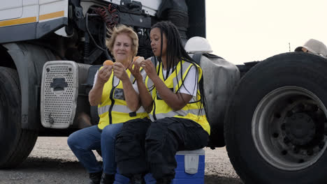 Female-truck-drivers-eating-snacks-and-talking