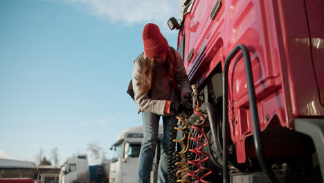 Woman-checking-the-wires-of-the-truck