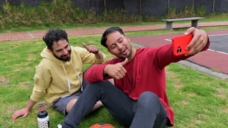 Men-sitting-on-the-grass-after-basketball-practice