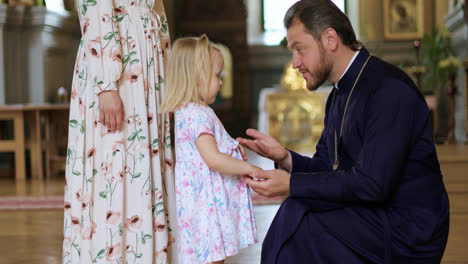 Priest-talking-with-little-child