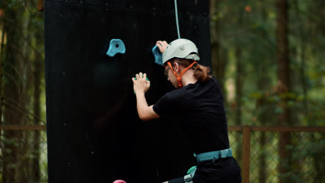 Person-climbing-wall-outdoors