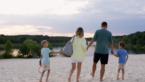 Family-holding-hands-on-the-beach
