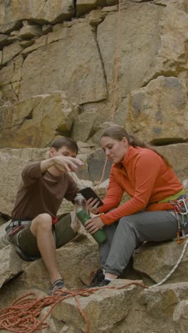 Climbers-sitting-at-the-bottom-of-the-cliff