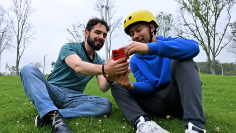 Two-men-sitting-on-the-grass