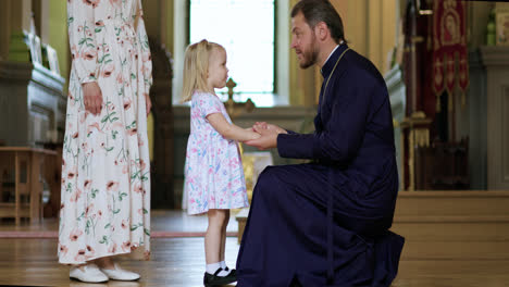 Little-child-talking-with-priest
