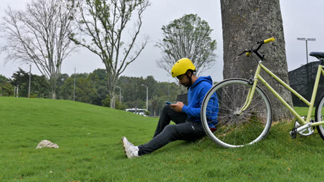 Latin-cyclist-sitting-on-the-grass