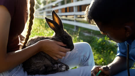 Farmer-holding-cute-bunny-outdoors