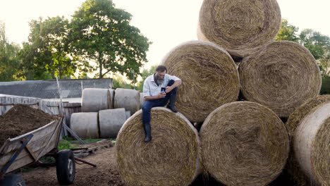 Man-sitting-on-haystack