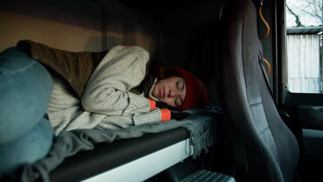 Woman-resting-inside-the-truck-cab