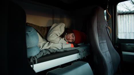 Woman-resting-inside-the-truck-cab