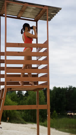 Side-view-of-female-lifeguard-at-the-beach