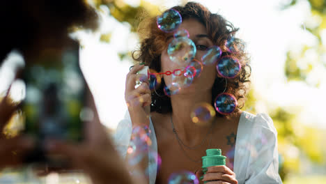 Woman-blowing-bubbles-outdoors