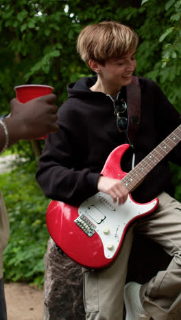 Girl-playing-guitar-outdoors