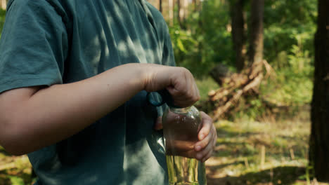 Boy-drinking-water-in-the-forest