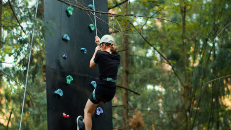 Boy-going-down-in-a-climbing-wall