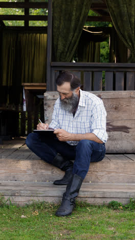 Man-sitting-out-of-the-cabin