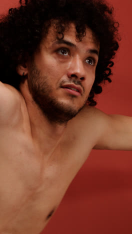 Young-man-dancing-in-a-red-room