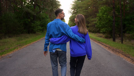Couple-walking-in-a-road