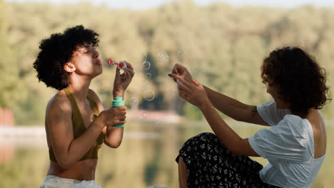 Women-blowing-bubbles-outdoors