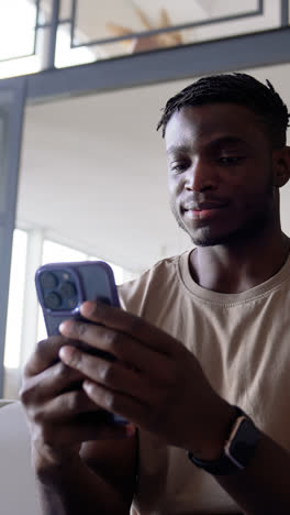 Man-using-phone-at-home