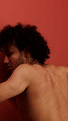 Young-man-dancing-in-a-red-room