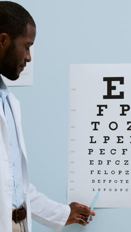 Doctor-pointing-at-Snellen-chart