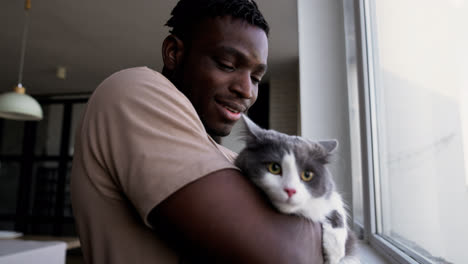 Pet-owner-with-his-cat-at-home