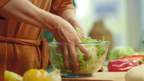 Woman-tossing-vegetable-salad