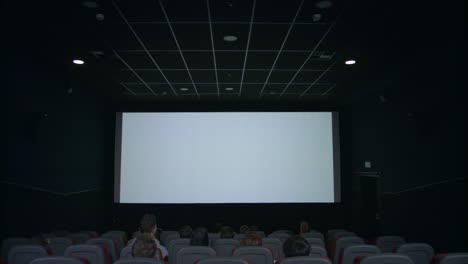 Publikum-Schaut-Auf-Die-Weiße-Leinwand-Im-Kinosaal