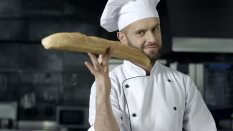 Close-up-view-of-man-hands-playing-with-bread-in-slow-motion