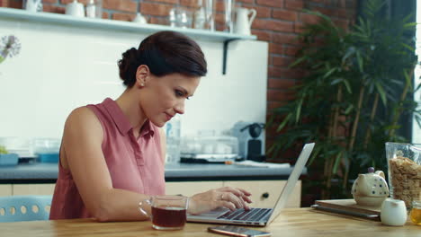 Woman-finishing-work-on-computer