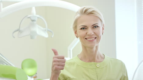 Happy-dentist-showing-thumb-up-in-dental-clinic